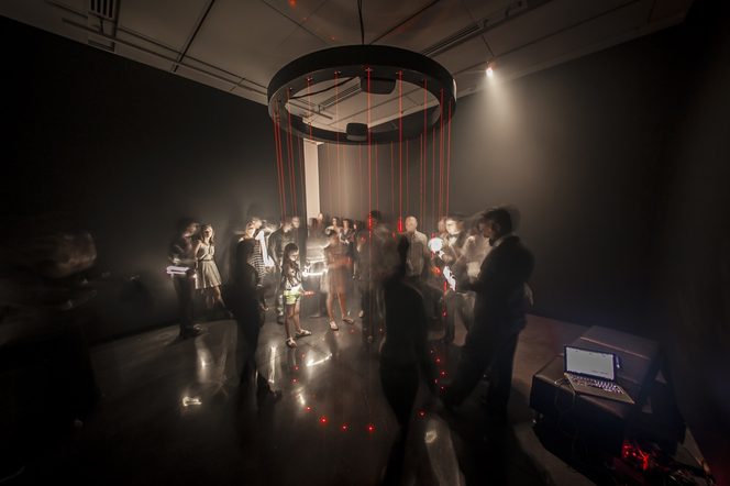 The Chandelier Harp, an interactive art installation where passing a hand through a low voltage laser produces a tone, by Jen Lewin Studio at an exhibition in the CU Art Museum. This solo exhibit was titled 'Its Electric' and featured a variety of light and sound based interactive art by artist Jen Lewin.